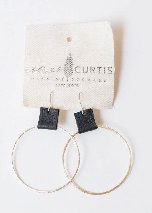 Grayson - Black. X Large (2.4 inches) brushed gold tone hoop with a small touch of distressed leather